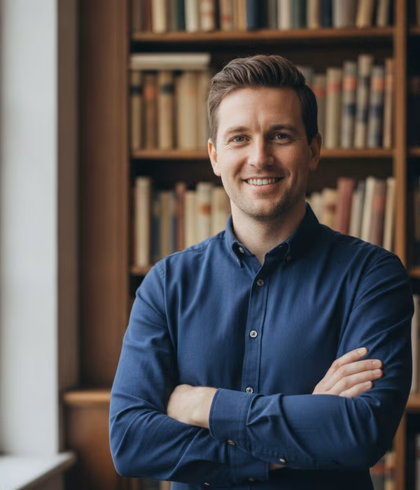 Marcus, founder of ApexYield, standing in front of bookshelves